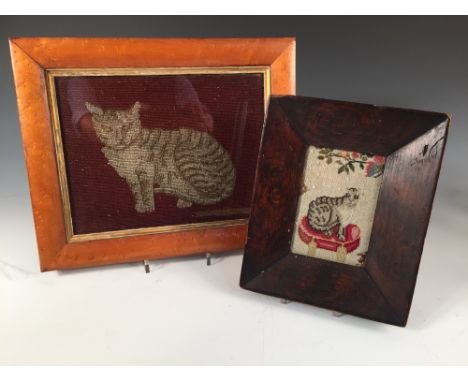 Two 19th century needlework pictures of cats, the smaller depicted sitting upon a red velvet cushion, the larger within a map