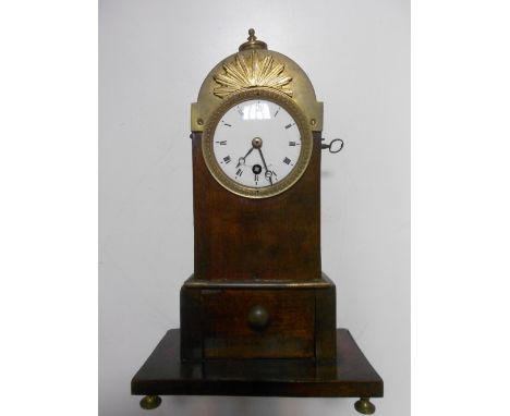 A French Empire mahogany mantel timepiece, the hinged domed top with finial above 6.5cm enamelled dial marked '**** Paris' ab