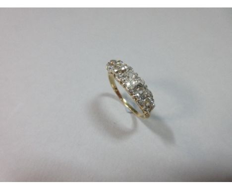 A five stone diamond ring, the graduated old cushion and round cut diamonds with rose cut diamond highlights in the interstic