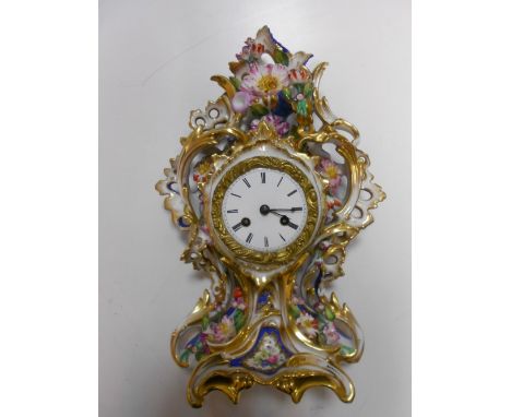 A French porcelain mantel clock, 19th century, the drum movement with silk suspension pendulum marked 'Raingo Freres Paris 15