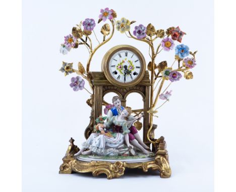 20th Century Gilt Brass and Porcelain Figural Mantle Clock. Blue stamp mark on underside of the figurine, clock unsigned. A f