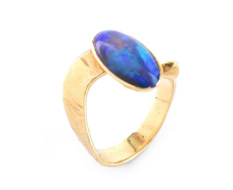 Vintage Oval Cabochon Black Opal and 14 Karat Yellow Gold Ring. Opal measures 12mm x 6.5mm. Unsigned. Very good vintage condi