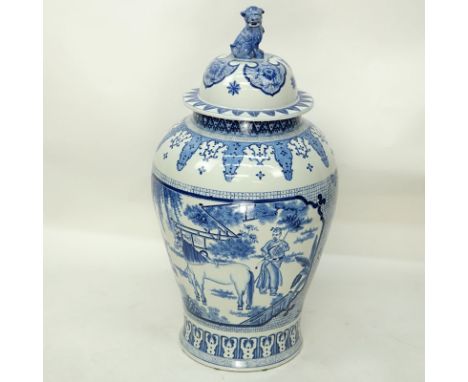 Large Mid Century Chinese Blue and White Porcelain Covered Urn with Foo Dog Finial. Depicting figures with horses on front an