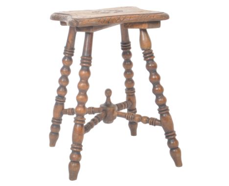 A 19th Century William &amp; Mary revival carved oak gypsy table having a shaped top with central decoration raised on four b