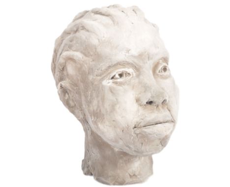 A 20th Century clay sculpture portrait bust depicting an young African girl. Detailed facial features with hair modelled brai