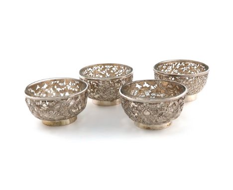 A set of four Chinese silver bowls, marked with Chinese characters and I.W, circular form, two pierced and embossed with drag