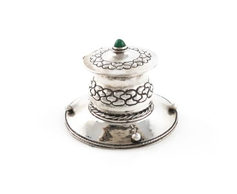 By Frederick Smythe-Greenwood, an Arts and Crafts silver inkwell, London 1914, circular form, embossed with lobed motifs, spo