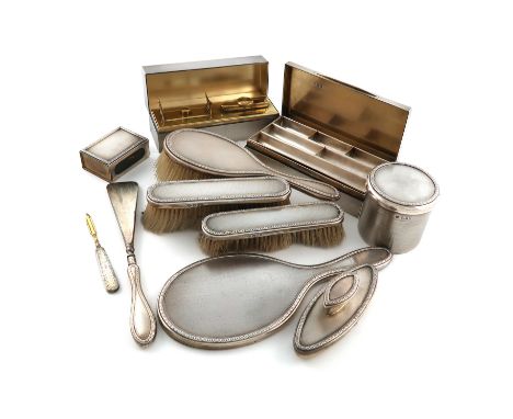 A silver dressing table set, by The Goldsmiths and Silversmiths Company, London 1913, with engine-turned decoration, foliate 