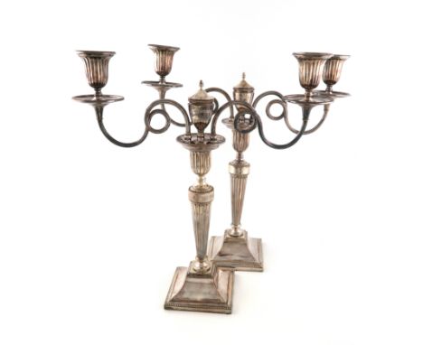 A pair of George III old Sheffield plated two-light candelabra, by J. Love and Co., circa 1790, tapering fluted columns, on r