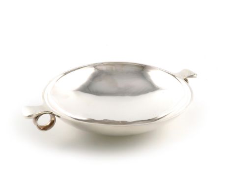 By Georg Jensen, a Danish silver dish, design no. 544, shallow circular form, lug and ring side handles, on a raised circular