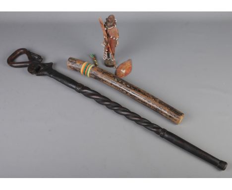 An African carved walking stick along with a rain maker and African tribal figure.  