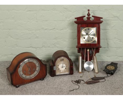 A collection of clocks featuring a Highland pendulum wall clock, The Alexander Clark Co mantel clock and others.  