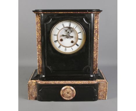 A black slate and marble mantel clock, with O. Berger movement on white enamel dial and Roman Numeral markers. Height: 39cm. 