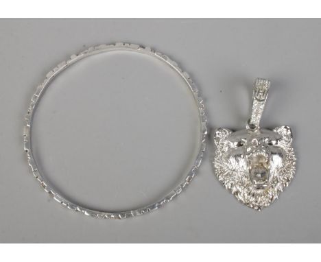 A Fischland thin silver bangle along with silver pendant formed as a snarling bear. Total weight 40g.  