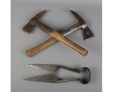 A Brades wooden handle fire axe, bearing military broad arrow mark and dated 1953, together with another similar example and 