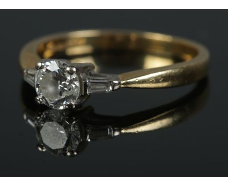 18ct gold and platinum ring set with central brilliant cut diamond (Approx. .5ct) flanked by two baguette diamonds. Size L Â½