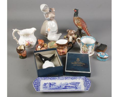 A quantity of ceramics. Includes Royal Crown Derby Pheasant, Beswick Koala, Nao by Lladro, Goebel, etc.  Repair to Royal Crow