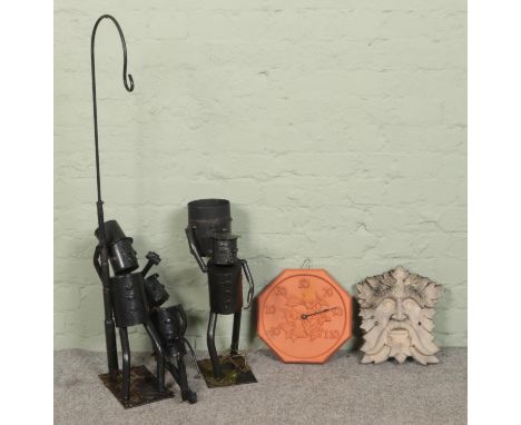 A collection of garden ornaments, to include goblin mask, temperature dial and three 'robot gnomes'.  