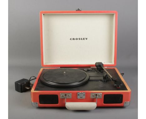 A Crosley portable record player. Model No. CR8005A-OR  Working, will need plus replacing and shell is completely broken.