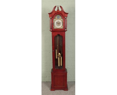 A modern German mahogany longcase clock featuring Westminster chime and "Tempus Fugit" motif to dial.  Crack to glass.