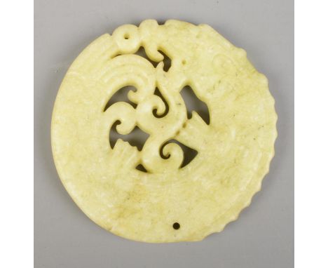 A jade bi disc formed as a coiled dragon. (7cm)  