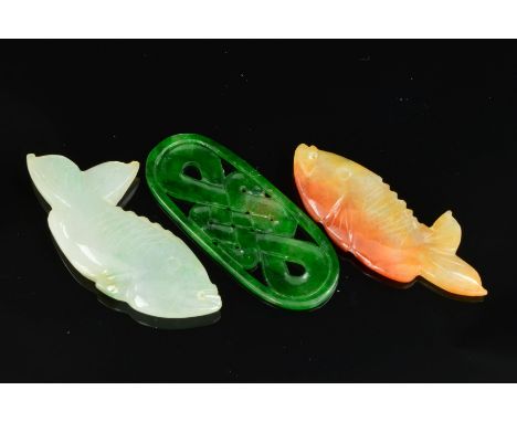 THREE PIECES OF CARVED JADEITE, to include two Koi Carp, one pale brown and one light green, each measuring 39mm x 19cmm, a d