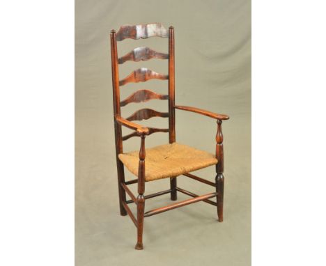 AN EARLY 19TH CENTURY ASH AND ELM RUSH SEATED ELBOW CHAIR, ladder back, turned stretchers and pad feet, height to top of back