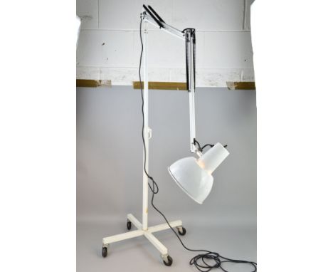 A VINTAGE INDUSTRIAL MOBILE MEDICAL EXAMINATION STANDARD LAMP by Anglepoise on castors