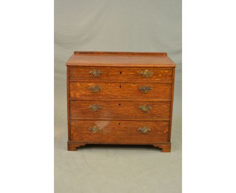 A GEORGE III OAK CHEST OF FOUR LONG GRADUATED DRAWERS, later short back, replacement brass swan neck handles and back plates,