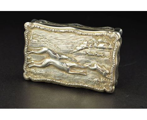 A VICTORIAN SILVER SNUFF BOX, of wavy rectangular outline, the raised relief hinged cover depicting two greyhounds chasing a 