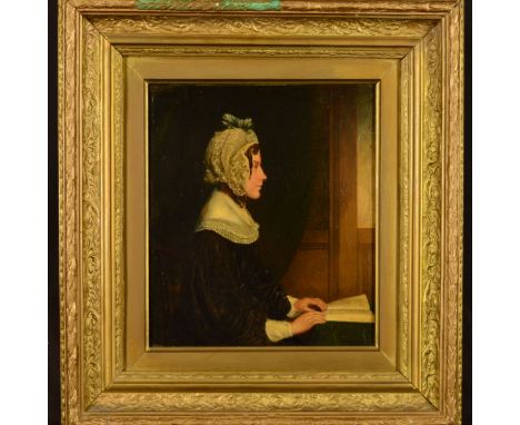 19TH CENTURY BRITISH SCHOOL, half length side profile portrait of a lady seated at a table with an open book, oil on panel be