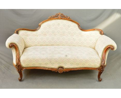 A VICTORIAN WALNUT FRAMED SOFA, the serpentine back with central carved and pierced foliate scroll and shell decoration, outw