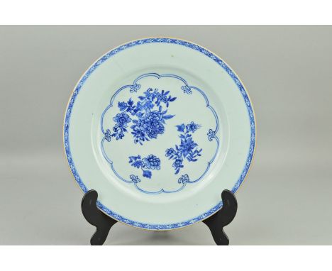 A CHINESE PORCELAIN PLATE, decorated with peony sprays in underglaze blue, lattice pattern border to the rim, Kangxi/Qianlong