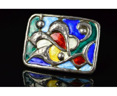 A NORWEGIAN ENAMEL BROOCH BY OYSTEIN BALLE, of rectangular outline with embossed scrolling and circular shapes to the mutli c