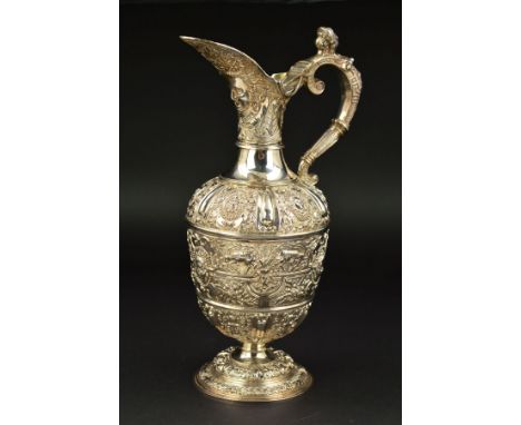 A VICTORIAN SILVER CELLINI PATTERN CLARET JUG, chased and embossed with masks and animals, the hinged cover with mask, 'S' sc