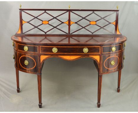 AN EDWARDIAN MAHOGANY AND INLAID BOW FRONT SIDEBOARD IN GEORGE III STYLE, the raised back with three brass urn finials above 