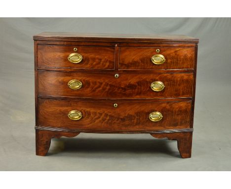 AN EARLY 19TH CENTURY MAHOGANY BOW FRONT CHEST OF TWO SHORT OVER TWO LONG GRADUATED DRAWERS, circular brass escutcheons with 