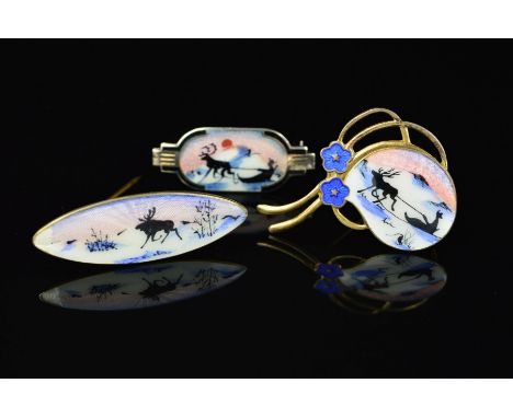 THREE NORWEGIAN ENAMEL BROOCHES BY ASKEL HOLMSEN, the first a rounded shape depicting an enamel reindeer and sleigh scene wit