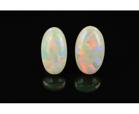 TWO OPAL OVAL CABOCHON CUT STONES, one measuring 24mm x 15mm, the other 23.7mm x 13.0mm, total weight 19.73ct, grey base colo