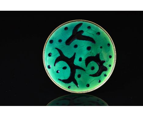 A NORWEGIAN ENAMEL BROOCH BY OYSTEIN BALLE, of circular outline with black enamel pointed and curved shapes and dots on a gre
