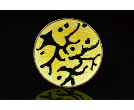 A NORWEGIAN ENAMEL BROOCH BY OYSTEIN BALLE, of circular outline with black enamel branch-like lines and dots on a yellow enam