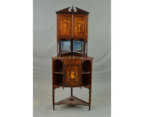 A LATE VICTORIAN ROSEWOOD AND INLAID FLOORSTANDING CORNER CUPBOARD, the architectural pediment with turned finial above doubl