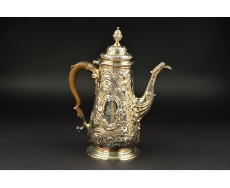 A GEORGE II SILVER COFFEE POT, of baluster form, hinged cover with urn finial, wooden handle, the body engraved with crest an