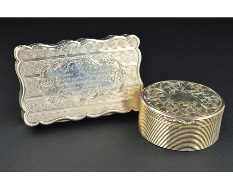 A VICTORIAN SILVER OVAL VINAIGRETTE, the hinged cover and base engraved with foliate scrolls, the sides ribbed, gilt interior