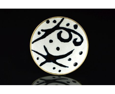 A NORWEGIAN ENAMEL BROOCH BY OYSTEIN BALLE, of circular outline with black enamel pointed and curved shapes and dots on a whi