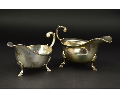 AN ELIZABETH II SILVER SAUCEBOAT, gadrooned rim, foliate cast 'S' scroll handle, on three cabriole legs with hoof feet, maker