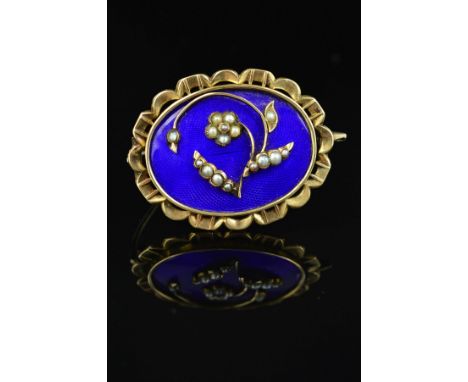 A MID VICTORIAN GOLD MEMORIAL BROOCH, blue enamel inlaid with floral seed pearl detail, oval shape with scalloped edge measur