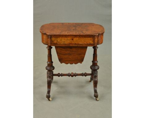 A VICTORIAN WALNUT AND BURR WALNUT WORK TABLE, of shaped oval outline, fitted with a drawer with compartments above a pull ou