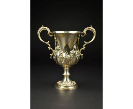 A VICTORIAN SILVER TWIN HANDLED TROPHY CUP, of lobed baluster form, gilt interior, repousse decorated and chased with acanthu