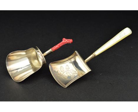 A GEORGE III SILVER CADDY SPOON, on a short coral handle, the shovel shaped bowl engraved to the reverse with cockerel crest 